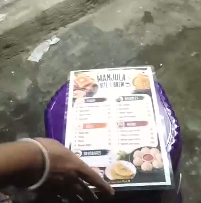 টুলের উপর রাখা ছাপানো মেনু কার্ড / The printed menu card resting on a stool